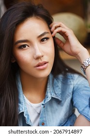 Beautiful Young Asian Woman Walking On A City Street With A White Dog. Summer Time. Outdoors.