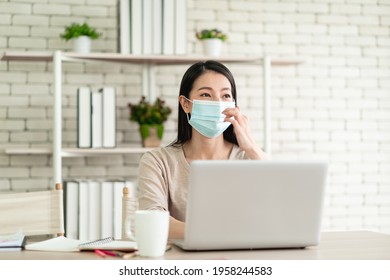 Beautiful Young Asian Woman Wearing A Surgical Mask, Working From Home And Feeling Happy Smiling With Joyful Expression