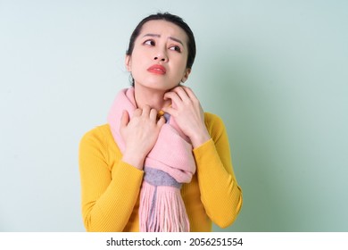 Beautiful Young Asian Woman Wearing Sweater On Green Background