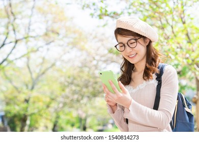 Beautiful young asian woman who travels in Kyoto,Japan,smart phone