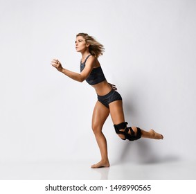 Beautiful Young Athletic Woman With A Knee Bandage Playing Sports Gymnastics Yoga, Recovery After Injury. Isolated