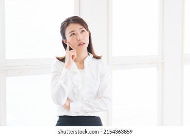 Beautiful young attractive asian businesswoman,think - Shutterstock ID 2154363859