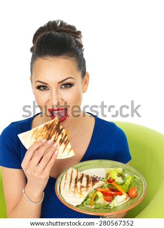 Beautiful Young Attractive Hispanic Woman Holding A Plate of Mexican Quesadula With Mixed Salad Against A White Background