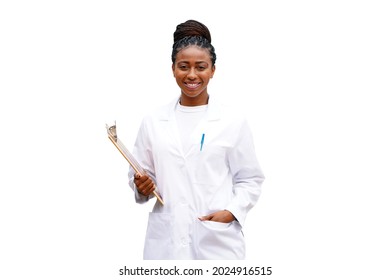Beautiful young black doctor or scientist stands against a white background wearing a white lab coat and holding a clipboard with braided hair, smiling                               