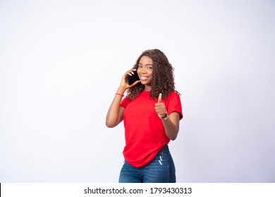 Beautiful Young Black Girl Making A Phone Call Giving A Thumbs Up