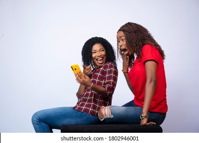 Beautiful Young Black Lady Showing Her Friend Something Exciting On Her Phone