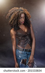 beautiful young black woman against a dramatic gold and purple grunge background