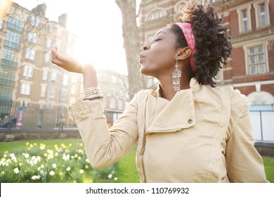 Beautiful Young Black Woman Holding The Sun In Her Hand At Sunset While Visiting London City.