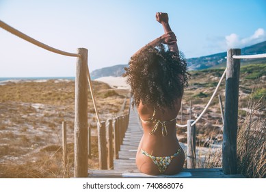 Beautiful Young Black Woman Sitting In A  Wooden Foot Bridge At The Beach