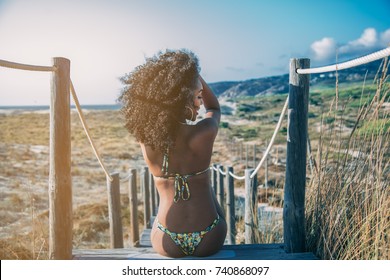 Beautiful Young Black Woman Sitting In A  Wooden Foot Bridge At The Beach
