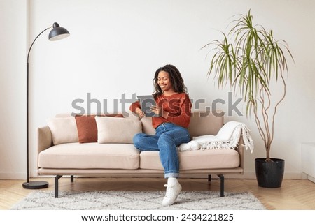 Similar – Image, Stock Photo Woman using tablet on a sunny bridge