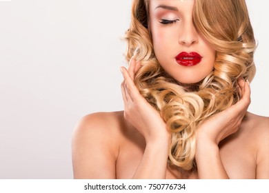 Beautiful young blond model curly hair posing on white - Shutterstock ID 750776734