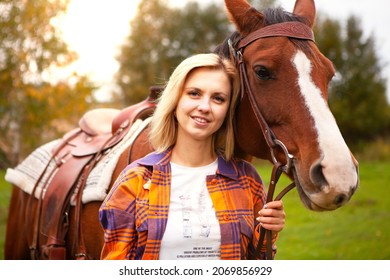 Beautiful Young Blond Woman With A Horse, Portrait. The Concept Of Love For Nature, Human Interaction With Nature And Animals.