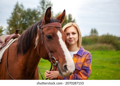 Beautiful Young Blond Woman With A Horse, Portrait. The Concept Of Love For Nature, Human Interaction With Nature And Animals.