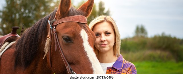 Beautiful Young Blond Woman With A Horse, Portrait. The Concept Of Love For Nature, Human Interaction With Nature And Animals.