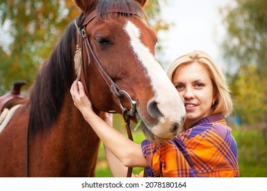 Beautiful Young Blond Woman With A Horse, Portrait. The Concept Of Love For Nature, Human Interaction With Nature And Animals.