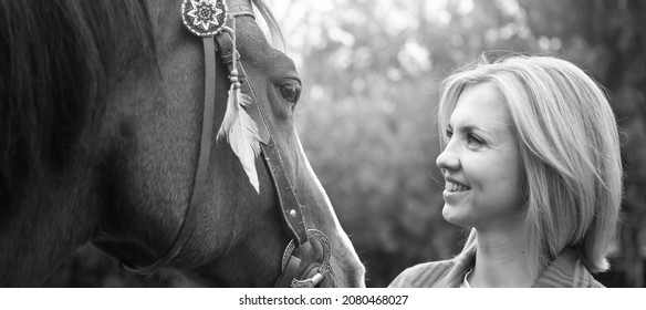 Beautiful Young Blond Woman With A Horse, Portrait. The Concept Of Love For Nature, Human Interaction With Nature And Animals.