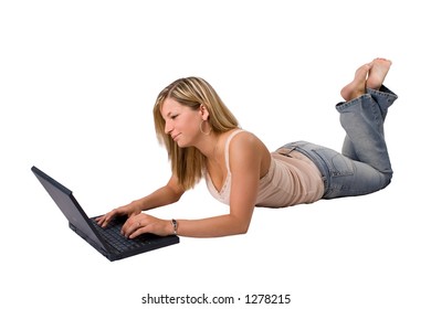 Beautiful Young Blond Woman Laying Down Using A Laptop Isolated On White