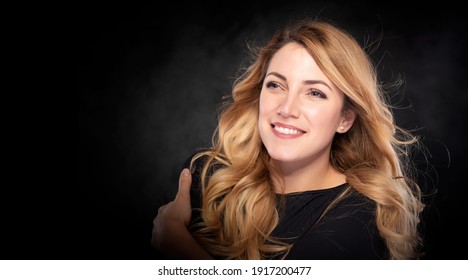 Beautiful Young Blond Woman Over Dark Background.