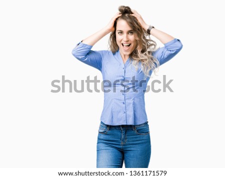 Beautiful young blonde business woman over isolated background Crazy and scared with hands on head, afraid and surprised of shock with open mouth