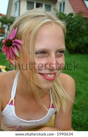 beautiful young blonde girl with flower in hair