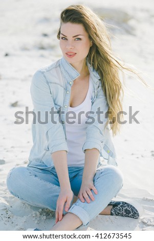 Similar – Young woman sits at the Baltic Sea beach