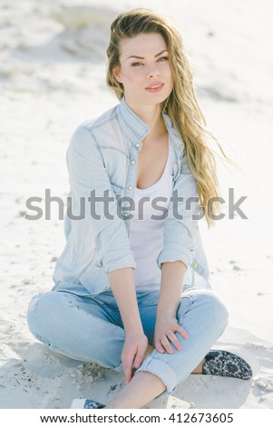 Similar – Young woman sits at the Baltic Sea beach