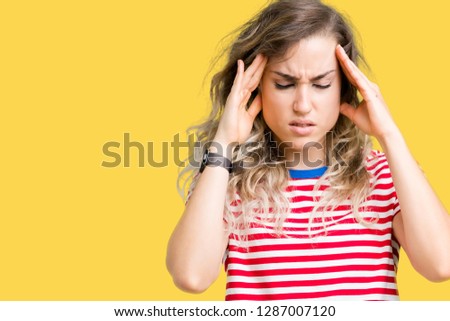 Beautiful young blonde woman over isolated background with hand on head for pain in head because stress. Suffering migraine.