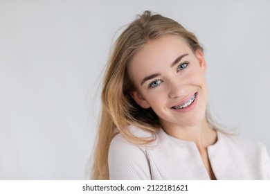 beautiful young blondes girl showing her dental braces - Shutterstock ID 2122181621
