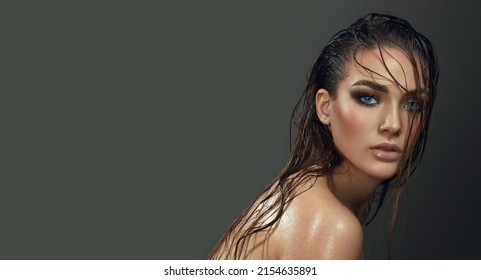 Beautiful Young Blue-eyed Woman With Wet Skin And Wet Hair In The Studio On A Gray Background. Close-up Portrait.