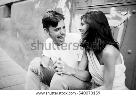 beautiful and young boy and girl sits near doors