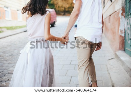 beautiful and young boy and girl walking down the street
