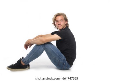 Beautiful Young Boy Sitting On The Ground