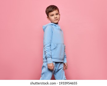 Beautiful Young Boy Wear Of Blue Set Of Track Suit Isolated On Pink Background