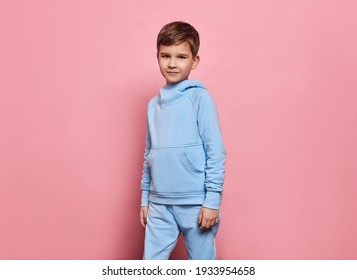 Beautiful Young Boy Wear Of Blue Set Of Track Suit Isolated On Pink Background