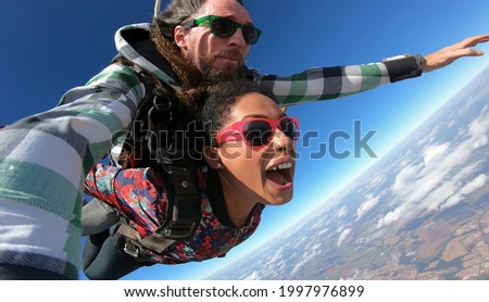 Beautiful young brazilian woman skydiving. 