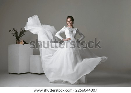 Similar – Image, Stock Photo bride in a long white dress with a wedding bouquet along with a groom in a stylish suit after a wedding ceremony in front wall with green ivy