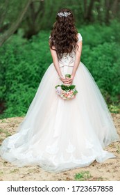 Beautiful young bride stands with her back