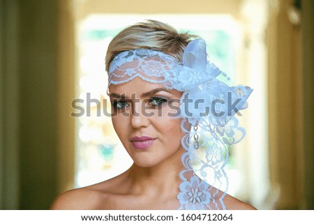 beautiful young bride, in a vintage retro dress, white, posing with flowers in her hands