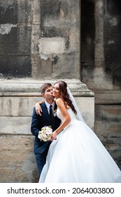 Beautiful Young Bride With Wedding Bouquet And Groom Near Old Castle Before Wedding Ceremony