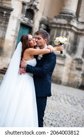 Beautiful Young Bride With Wedding Bouquet And Groom Near Old Castle Before Wedding Ceremony