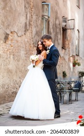 Beautiful Young Bride With Wedding Bouquet And Groom Near Old Castle Before Wedding Ceremony