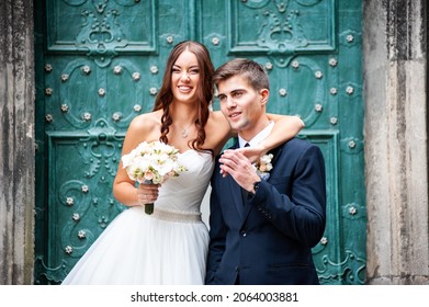 Beautiful Young Bride With Wedding Bouquet And Groom Near Old Castle Before Wedding Ceremony