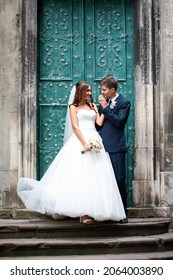 Beautiful Young Bride With Wedding Bouquet And Groom Near Old Castle Before Wedding Ceremony