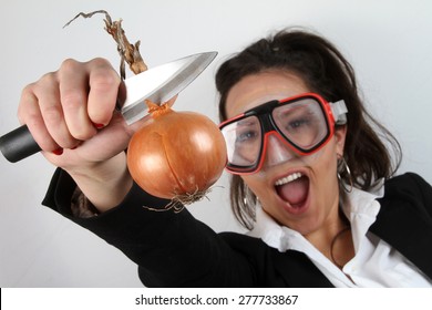 beautiful young brunette cook onion peels with a diving mask on her face - funny facial expressions - Powered by Shutterstock