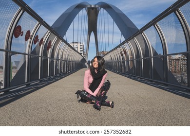 Beautiful Young Brunette With Over The Knee Boots Posing On A Bridge