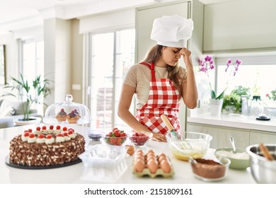 Beautiful Young Brunette Pastry Chef Woman Cooking Pastries At The Kitchen Tired Rubbing Nose And Eyes Feeling Fatigue And Headache. Stress And Frustration Concept. 