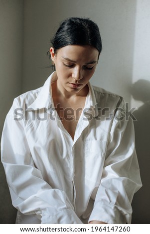 Similar – Young female sitting by table and making clay or ceramic mug in her working studio