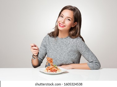 Beautiful Young Brunette Woman Eating Italian Pasta.