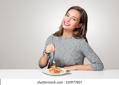 Beautiful Young Brunette Woman Eating Italian Pasta.